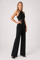 https://cdn.shopify.com/s/files/1/0682/7661/7389/files/ElieSiyahJumpsuit03-SideSmilePose.jpg?v=1777823991